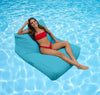 Woman in a red bikini lying on a blue bean bag lounge in a pool.