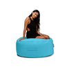 Woman sitting on a blue bean bag chair against a white background
