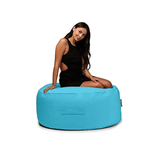 Woman sitting on a blue bean bag chair against a white background